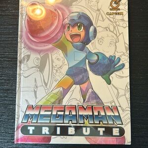 Mega man tribute hard cover book. Still in plastic wrapping.